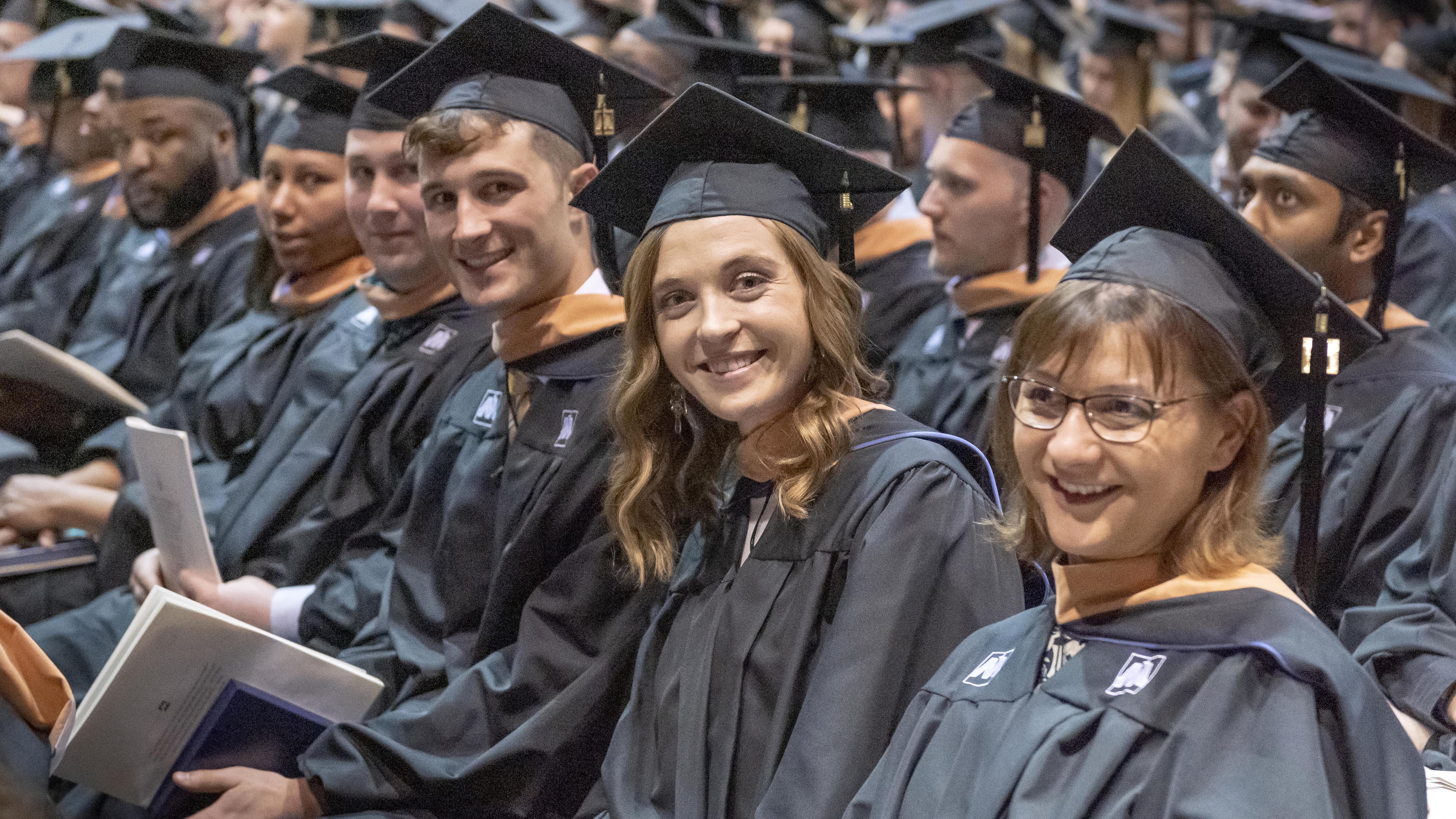 University of Mary graduates smiling during commencement.